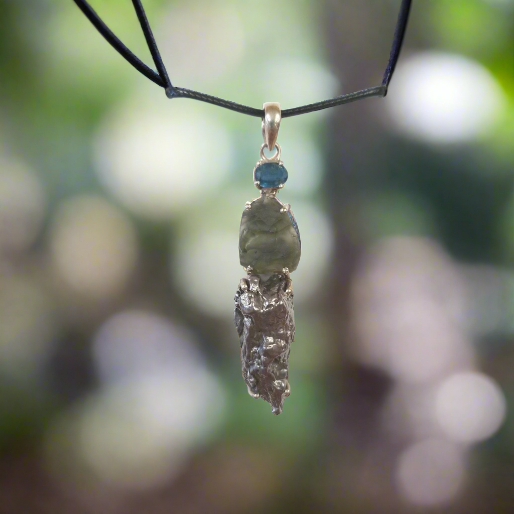 Experience the healing power of our Beautiful Moldavite Necklace! This stunning piece is made with genuine indigo kyanite, moldavite, and Campo Del Cielo meteorite. The indigo kyanite promotes spiritual growth and the moldavite is known for its transformative abilities. This necklace is sure to bring balance and positive energy into your life.