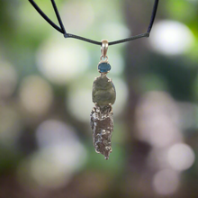 Experience the healing power of our Beautiful Moldavite Necklace! This stunning piece is made with genuine indigo kyanite, moldavite, and Campo Del Cielo meteorite. The indigo kyanite promotes spiritual growth and the moldavite is known for its transformative abilities. This necklace is sure to bring balance and positive energy into your life.
