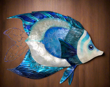 Blue and White Capiz Shell Decor.  This piece is made from Metal 15 inches Long And 19 inches wide.  This will look great with any home Decor With exquisite craftsmanship and durable materials, this Blue and White Capiz Wall Decor Fish is a stunning addition to any home. Measuring 15 inches in length and 19 inches in width, this piece is the perfect size for any room. Bring a touch of coastal charm to your home decor with this beautiful piece.