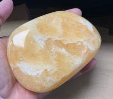This Large Orange Calcite Tumbled Stone boasts powerful healing properties. With its vibrant color and smooth texture, it's a must-have for crystal collectors and spiritual enthusiasts alike. With its ability to amplify energy and promote emotional balance, this tumbled stone is the perfect addition to any collection.