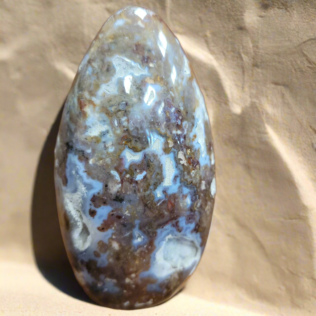 This exquisite Agate Freeform is a statement piece that will elevate any home decor. Meticulously crafted from natural agate, its unique free-form design showcases the stunning patterns and colors of this beautiful gemstone. Add a touch of natural elegance to your living space with this beautiful Agate Freeform.This agate freeform weighs approx. 1.220 kg