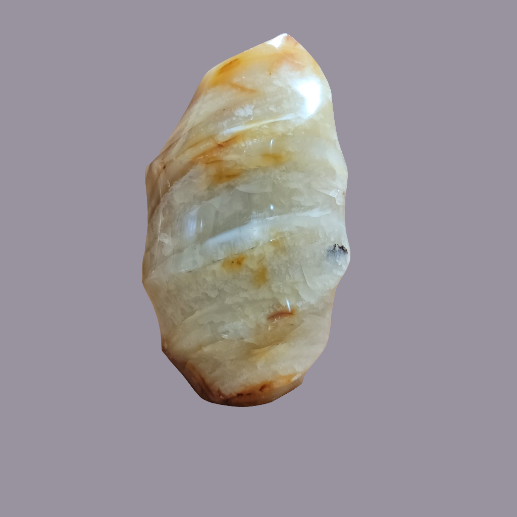This Carnelian Flame from Madagascar is a stunning standing flame that will enhance any space. With its smooth, polished surface and fiery orange color, it brings a sense of warmth and vitality. Carnelian is known for its ability to boost energy, creativity, and motivation, making it a perfect addition to your home or office.This flame weighs approx. .815 kg
