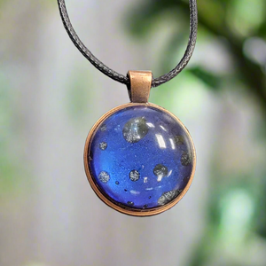 This resin handmade necklace by SB is a unique and elegant accessory that will add a touch of sophistication to any outfit. Crafted with care, its purple moon design is eye-catching and will surely stand out. Elevate your style with this beautiful and one-of-a-kind necklace.