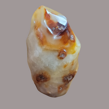 This Carnelian Flame from Madagascar is a stunning standing flame that will enhance any space. With its smooth, polished surface and fiery orange color, it brings a sense of warmth and vitality. Carnelian is known for its ability to boost energy, creativity, and motivation, making it a perfect addition to your home or office.This flame weighs approx. .815 kg