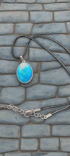 This handmade resin blue and white pendant by SB features a unique swirling design, reminiscent of ocean waves. Each piece is carefully crafted to capture the beauty of sea colors, making it a one-of-a-kind accessory. Add a touch of elegance and nature to your outfit with this stunning necklace.