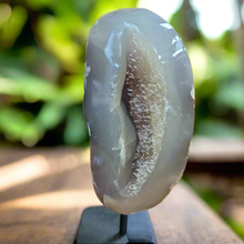 
Add natural beauty and spiritual energy to your home decor with our Agate Specimen on Stand. This geode specimen is mounted on a pin for easy display and its unique patterns make it a stunning addition to any room. Bring a touch of nature and positivity into your space with this beautiful and meaningful piece.