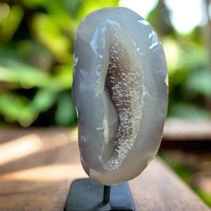 
Add natural beauty and spiritual energy to your home decor with our Agate Specimen on Stand. This geode specimen is mounted on a pin for easy display and its unique patterns make it a stunning addition to any room. Bring a touch of nature and positivity into your space with this beautiful and meaningful piece.