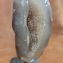 
Add natural beauty and spiritual energy to your home decor with our Agate Specimen on Stand. This geode specimen is mounted on a pin for easy display and its unique patterns make it a stunning addition to any room. Bring a touch of nature and positivity into your space with this beautiful and meaningful piece.