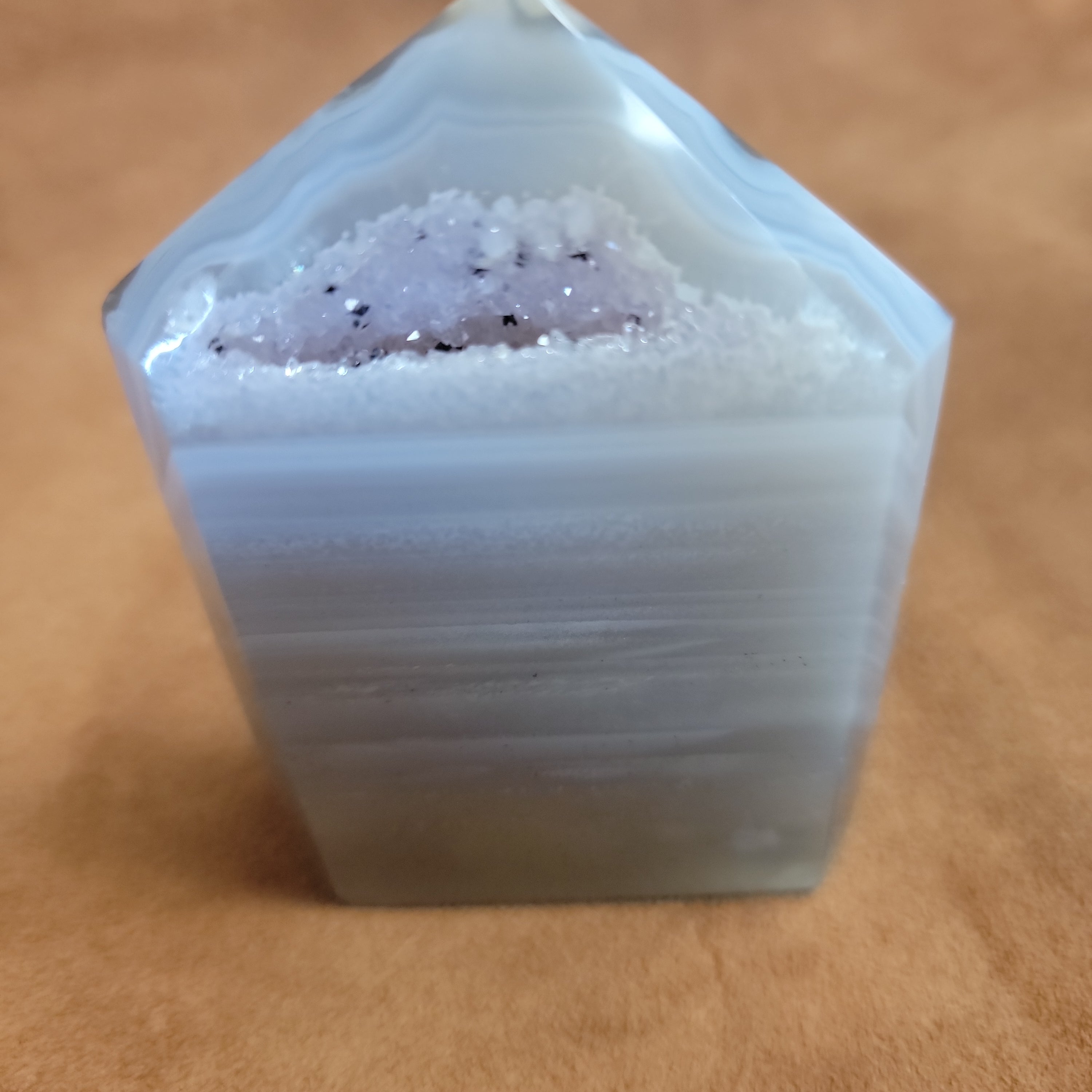 Discover the natural beauty of our Agate with Purple Druzy. This stunning home decor piece features a unique agate stone with a beautiful druzy crystal formation, adding a touch of elegance to any space. Elevate your home decor with this one-of-a-kind piece.