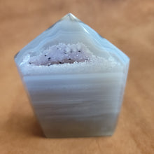 Discover the natural beauty of our Agate with Purple Druzy. This stunning home decor piece features a unique agate stone with a beautiful druzy crystal formation, adding a touch of elegance to any space. Elevate your home decor with this one-of-a-kind piece.