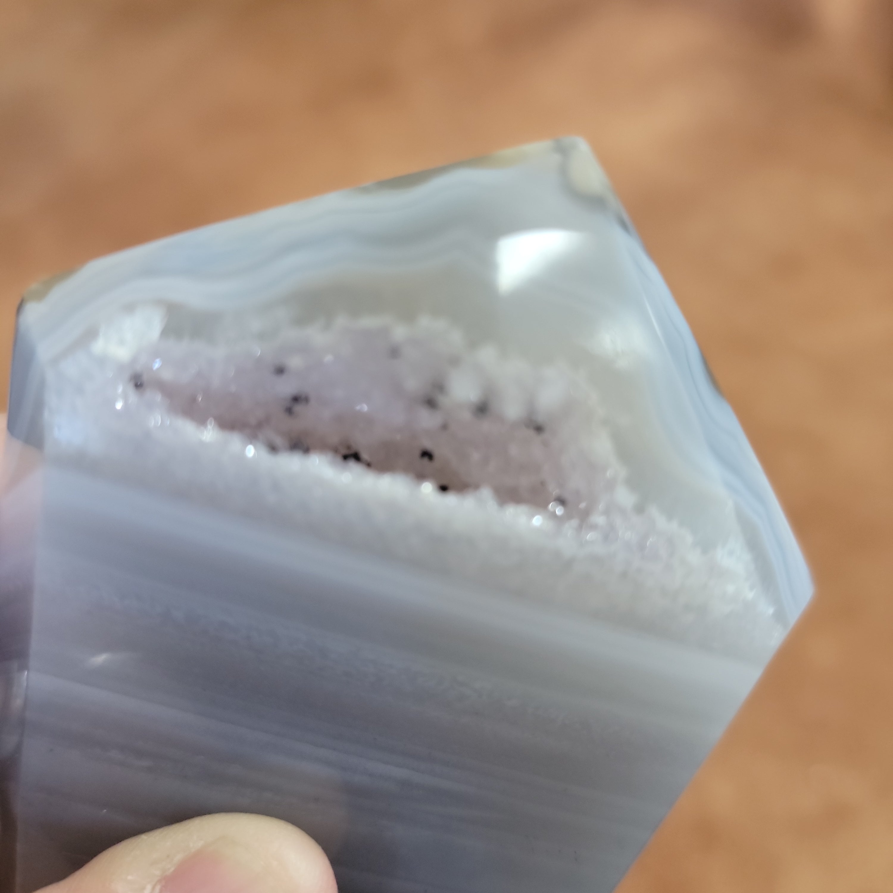 Discover the natural beauty of our Agate with Purple Druzy. This stunning home decor piece features a unique agate stone with a beautiful druzy crystal formation, adding a touch of elegance to any space. Elevate your home decor with this one-of-a-kind piece.