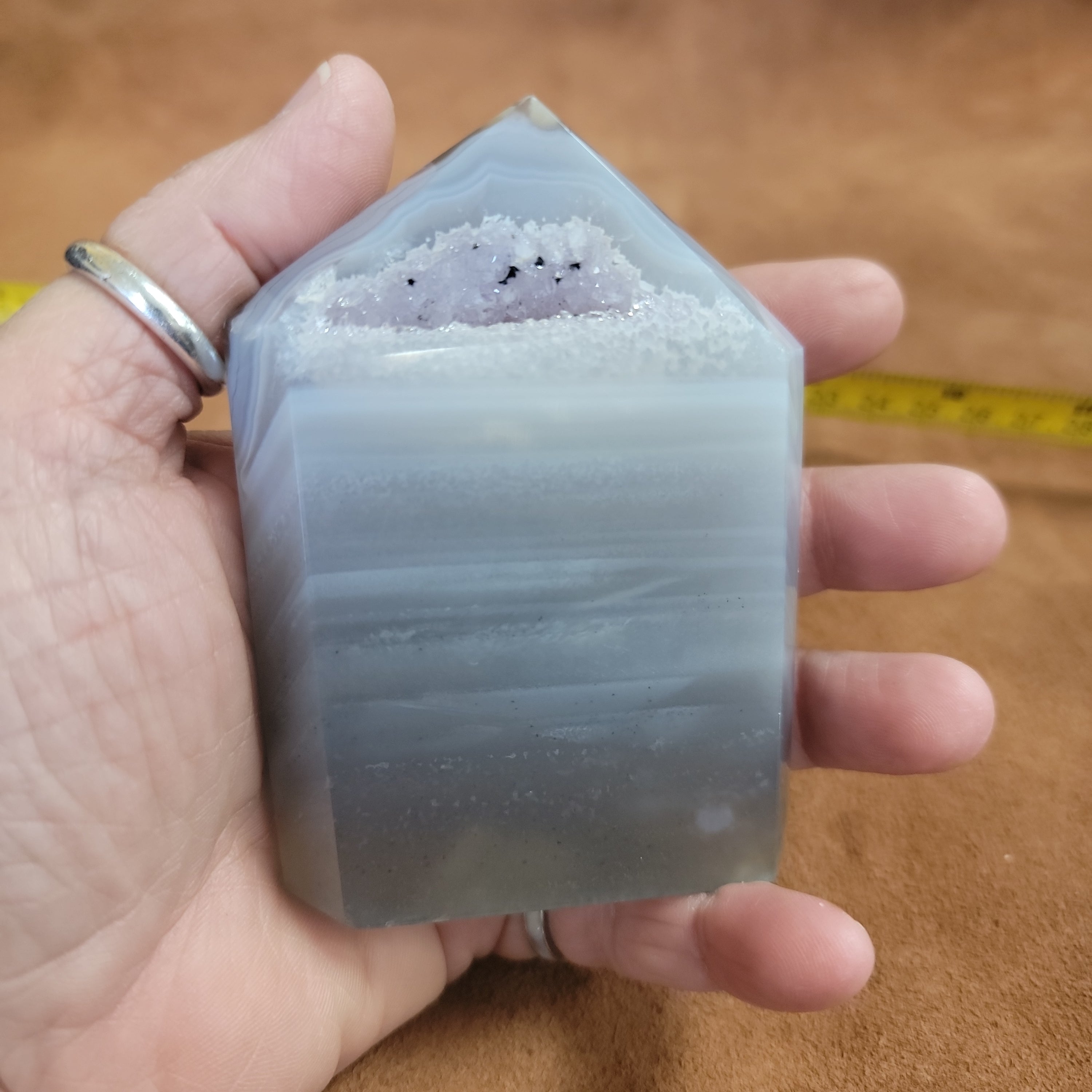 Discover the natural beauty of our Agate with Purple Druzy. This stunning home decor piece features a unique agate stone with a beautiful druzy crystal formation, adding a touch of elegance to any space. Elevate your home decor with this one-of-a-kind piece.