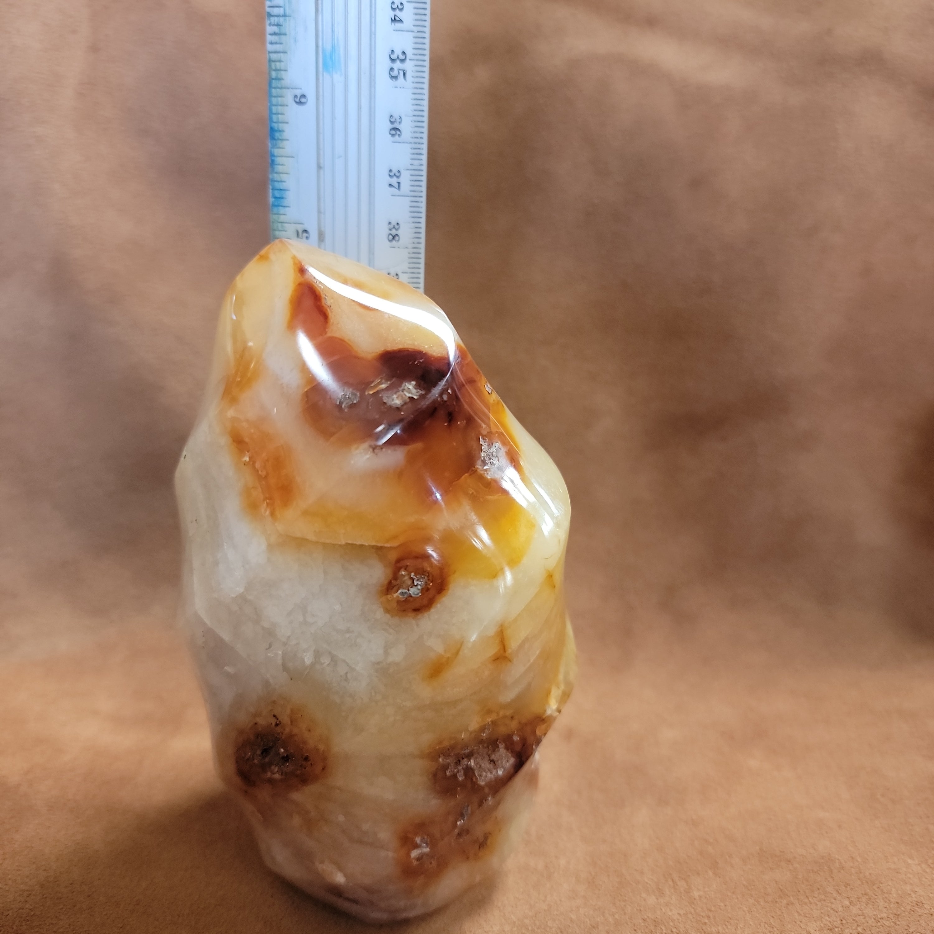 This Carnelian Flame from Madagascar is a stunning standing flame that will enhance any space. With its smooth, polished surface and fiery orange color, it brings a sense of warmth and vitality. Carnelian is known for its ability to boost energy, creativity, and motivation, making it a perfect addition to your home or office.This flame weighs approx. .815 kg