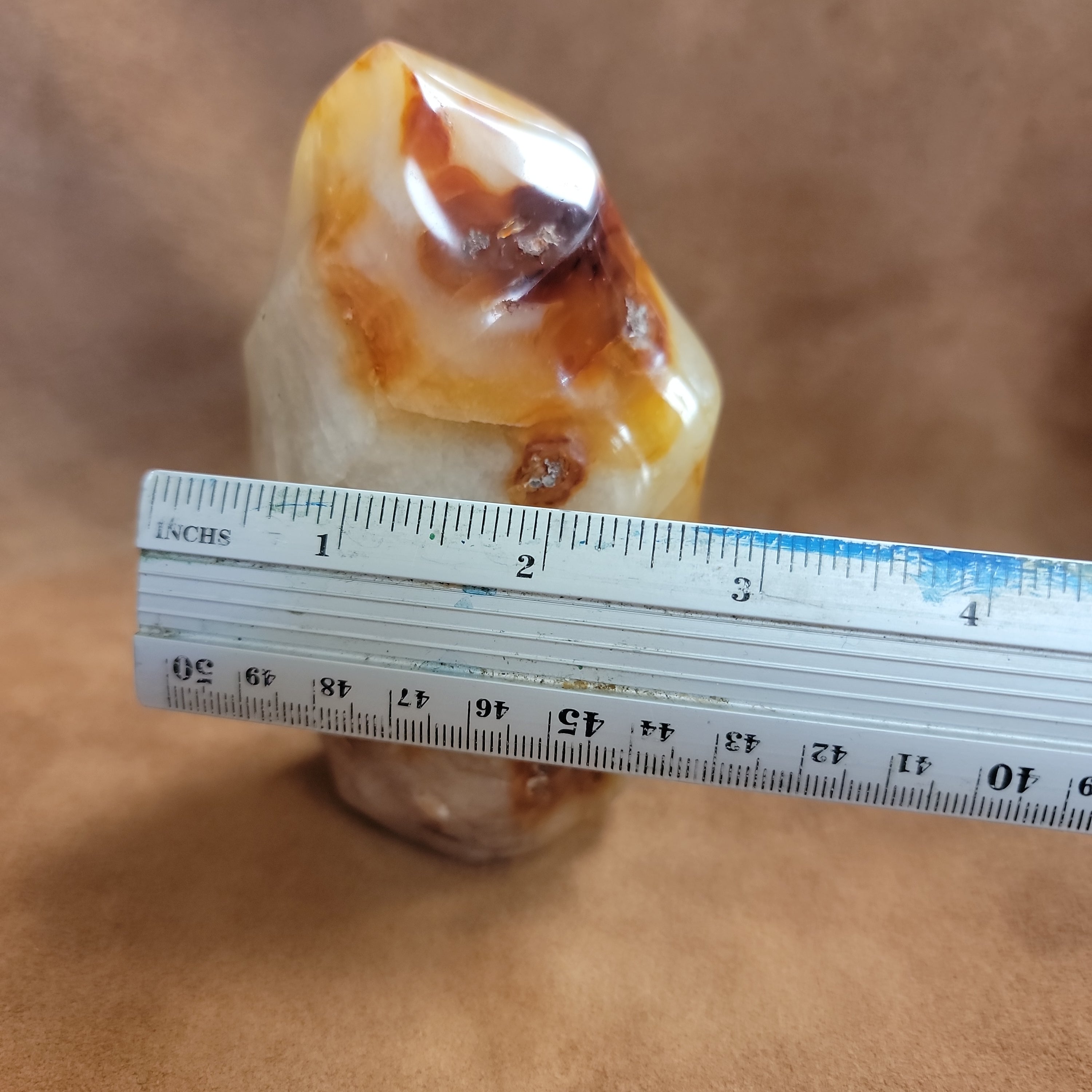 This Carnelian Flame from Madagascar is a stunning standing flame that will enhance any space. With its smooth, polished surface and fiery orange color, it brings a sense of warmth and vitality. Carnelian is known for its ability to boost energy, creativity, and motivation, making it a perfect addition to your home or office.This flame weighs approx. .815 kg