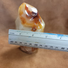 This Carnelian Flame from Madagascar is a stunning standing flame that will enhance any space. With its smooth, polished surface and fiery orange color, it brings a sense of warmth and vitality. Carnelian is known for its ability to boost energy, creativity, and motivation, making it a perfect addition to your home or office.This flame weighs approx. .815 kg