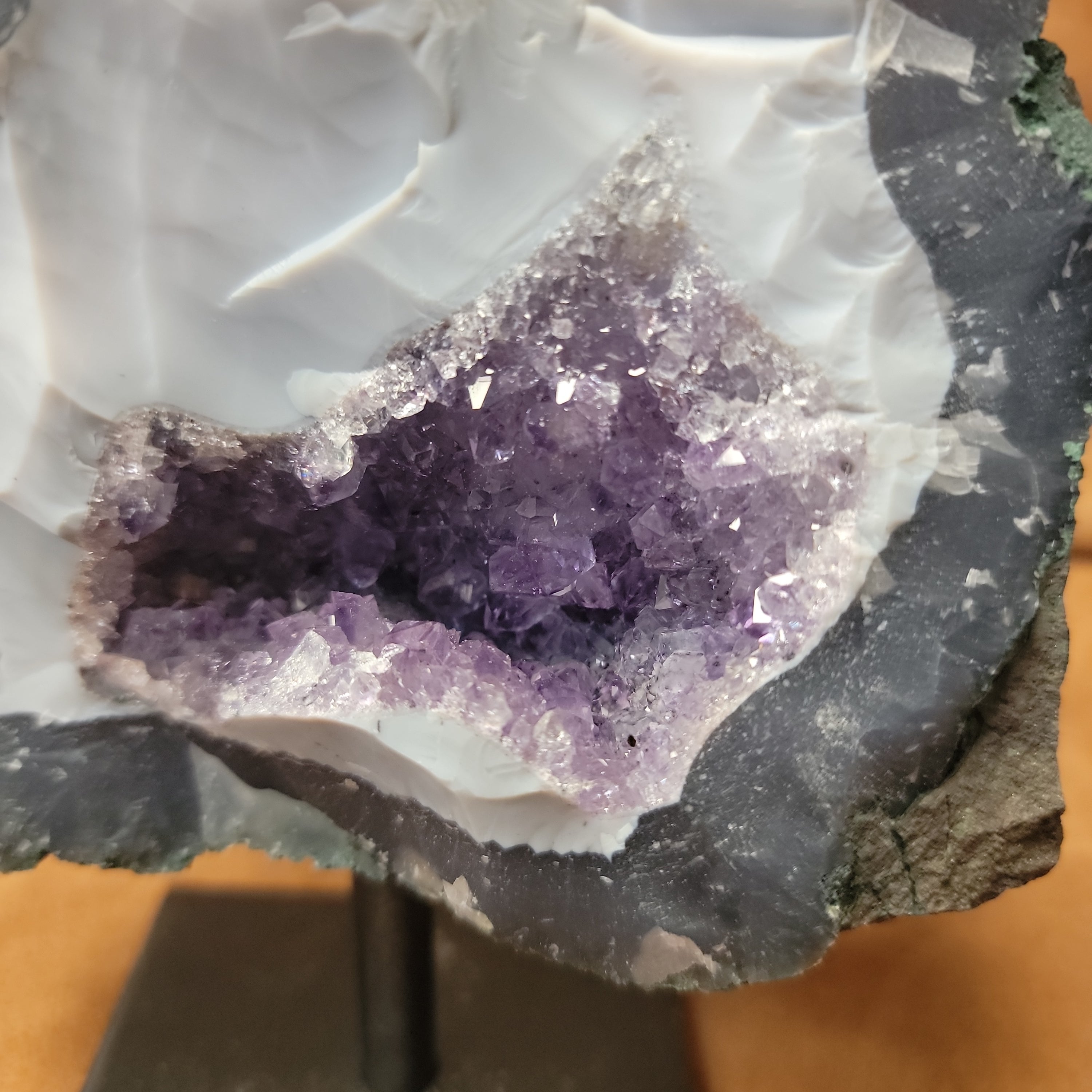 Elevate your home decor with our stunning Amethyst Speciman, featuring a beautiful purple hue and a sleek metal base. Bring a touch of elegance to any room with this unique and eye-catching centerpiece. Perfect for adding a sophisticated and calming atmosphere to your living space.