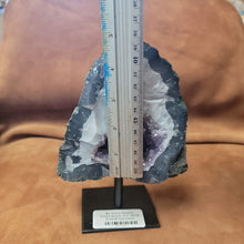 Elevate your home decor with our stunning Amethyst Speciman, featuring a beautiful purple hue and a sleek metal base. Bring a touch of elegance to any room with this unique and eye-catching centerpiece. Perfect for adding a sophisticated and calming atmosphere to your living space.