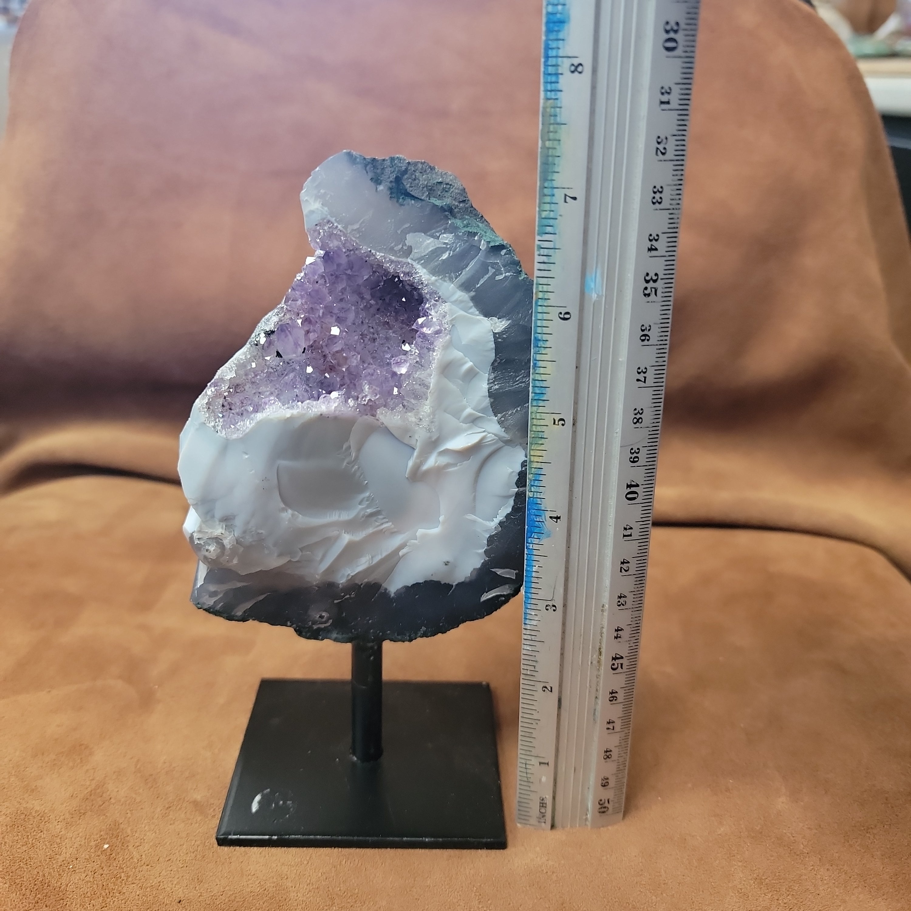 Experience the natural beauty and positive energy of our Amethyst Speciman with metal base. This carefully selected crystal is delicately pinned for home decor, bringing a touch of elegance and grounding energy to any space. Embrace the benefits of Amethyst, known for its calming and healing properties.
