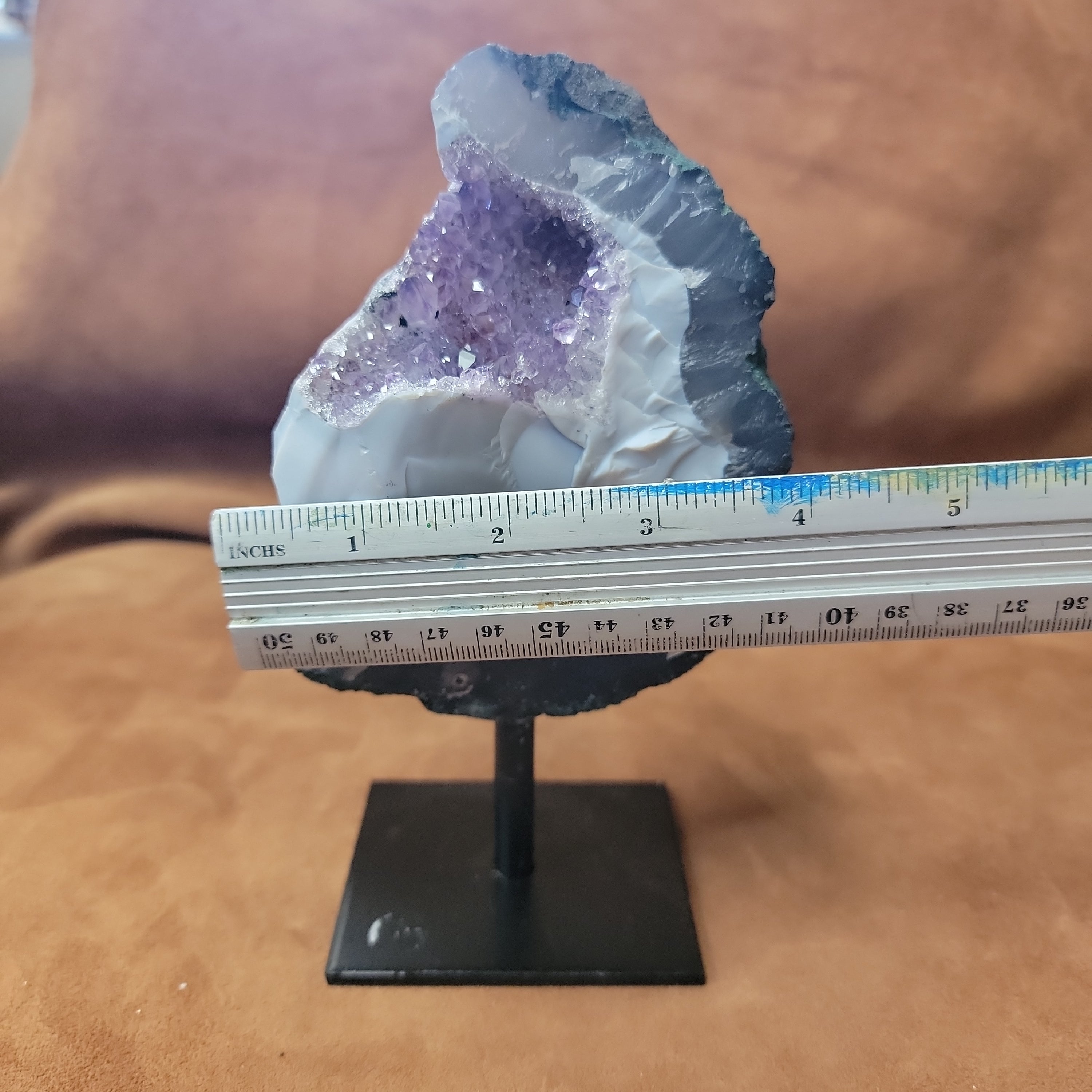 Experience the natural beauty and positive energy of our Amethyst Speciman with metal base. This carefully selected crystal is delicately pinned for home decor, bringing a touch of elegance and grounding energy to any space. Embrace the benefits of Amethyst, known for its calming and healing properties.