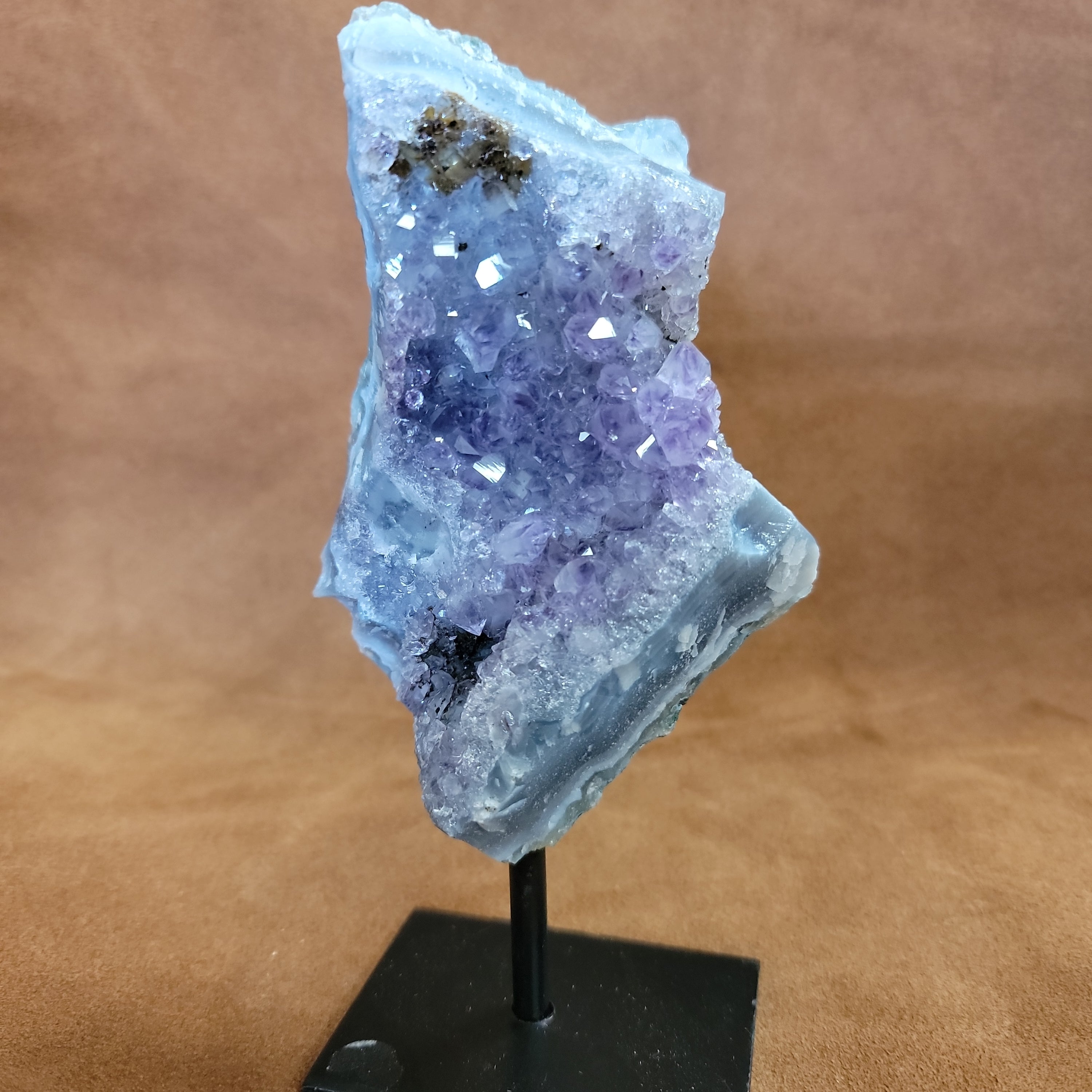 As a product expert, I can confidently state that our Amethyst on a Stand boasts a stunning display of brilliant color. Each piece is hand-selected for its vibrant hues, ensuring a bold and unique addition to any collection. Transform your space with this natural wonder.Beautiful Amethyst on a pin stand measure approx 6.5 inches tall