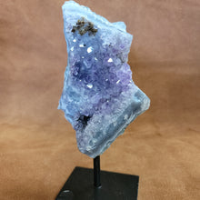 As a product expert, I can confidently state that our Amethyst on a Stand boasts a stunning display of brilliant color. Each piece is hand-selected for its vibrant hues, ensuring a bold and unique addition to any collection. Transform your space with this natural wonder.Beautiful Amethyst on a pin stand measure approx 6.5 inches tall