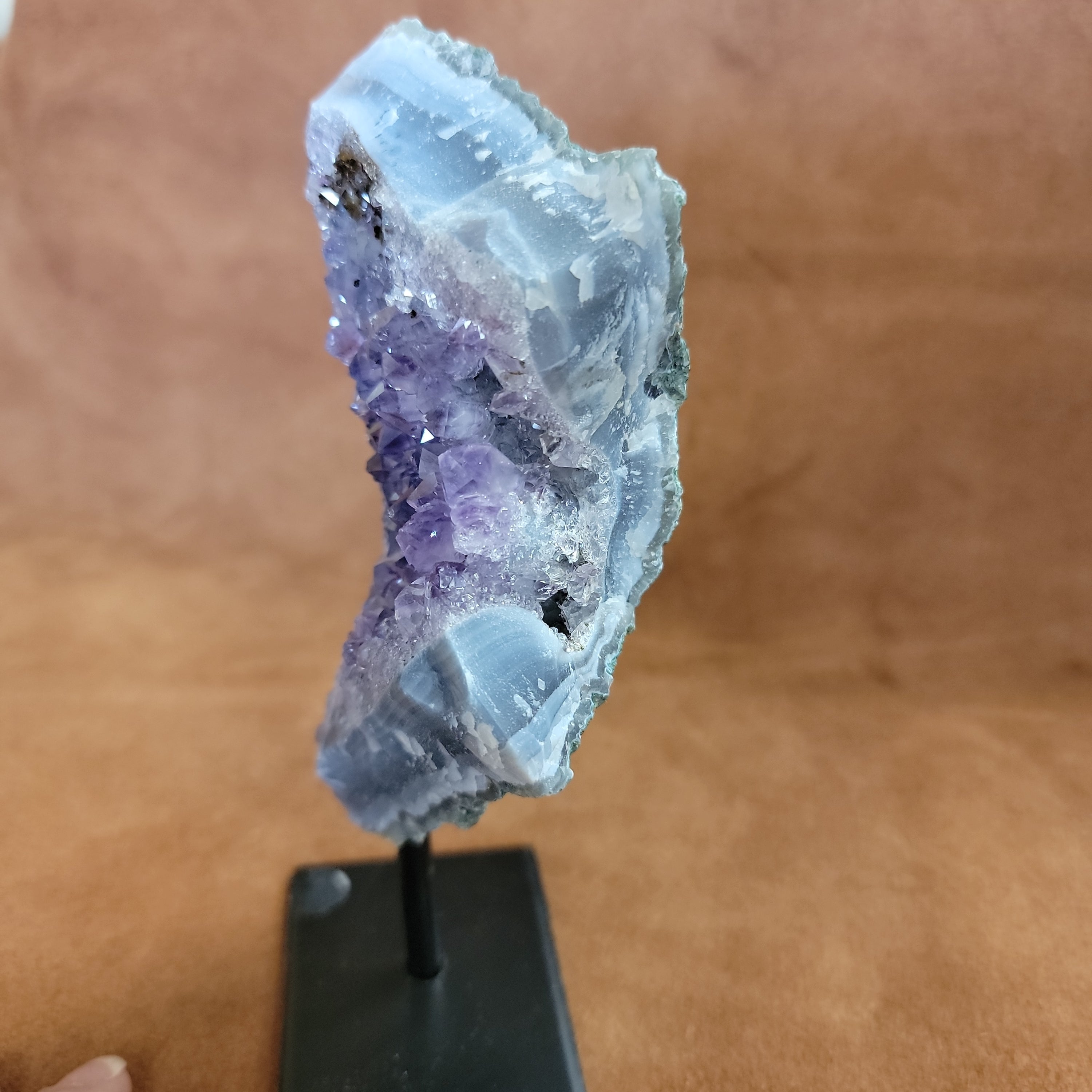 As a product expert, I can confidently state that our Amethyst on a Stand boasts a stunning display of brilliant color. Each piece is hand-selected for its vibrant hues, ensuring a bold and unique addition to any collection. Transform your space with this natural wonder.Beautiful Amethyst on a pin stand measure approx 6.5 inches tall
