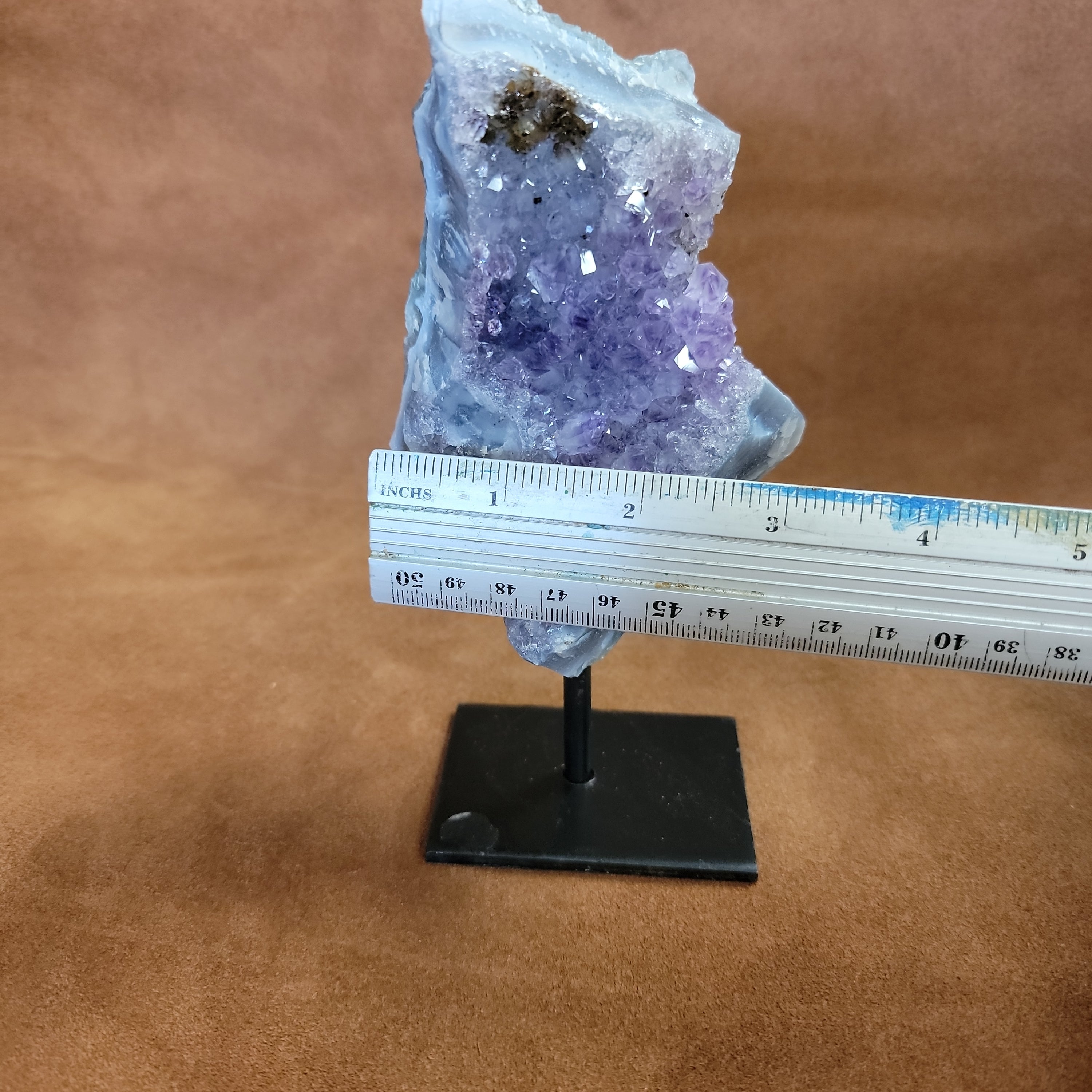 As a product expert, I can confidently state that our Amethyst on a Stand boasts a stunning display of brilliant color. Each piece is hand-selected for its vibrant hues, ensuring a bold and unique addition to any collection. Transform your space with this natural wonder.Beautiful Amethyst on a pin stand measure approx 6.5 inches tall