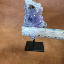 As a product expert, I can confidently state that our Amethyst on a Stand boasts a stunning display of brilliant color. Each piece is hand-selected for its vibrant hues, ensuring a bold and unique addition to any collection. Transform your space with this natural wonder.Beautiful Amethyst on a pin stand measure approx 6.5 inches tall