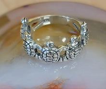 This Turtle ring is a size 8 it has 925 stamp and 5 turtles side by side. 