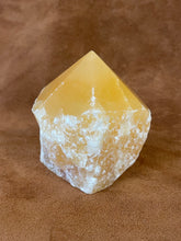 Orange calcite polished point